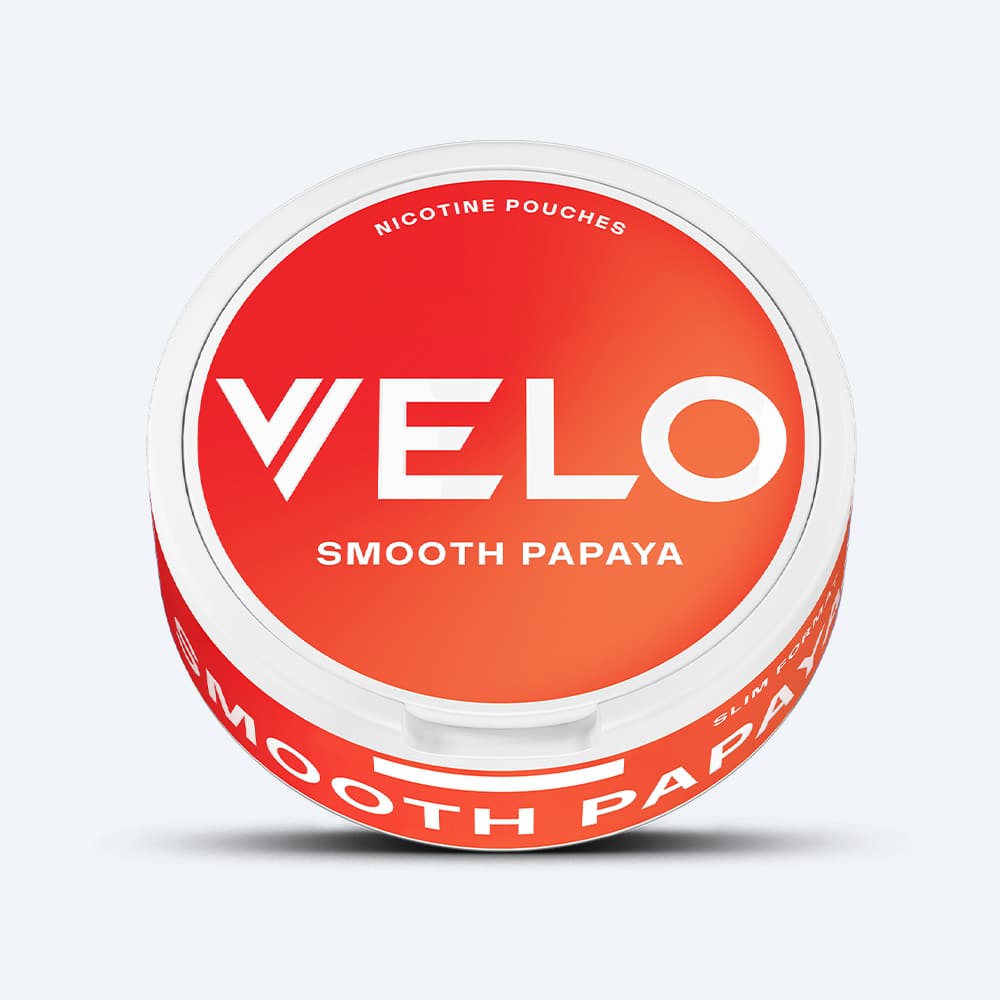 A round container of VELO Smooth Papaya nicotine pouches with a red lid featuring the brand name, offering a balanced taste and tropical flavour.