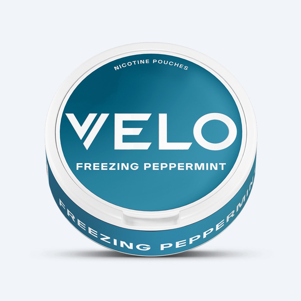 A round, blue container of VELO Freezing Peppermint nicotine pouches with white text.