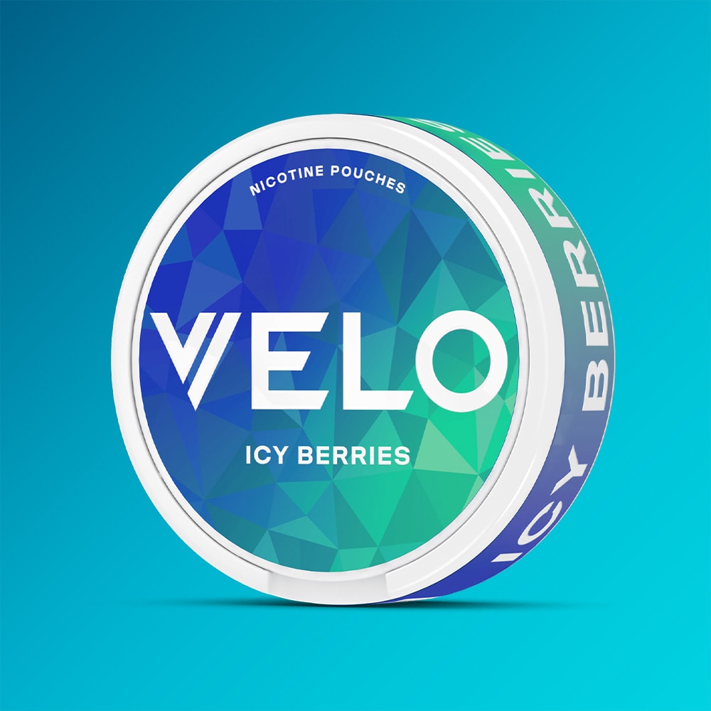 A circular container of VELO Icy Berries nicotine pouches with a blue and green geometric pattern on the lid.