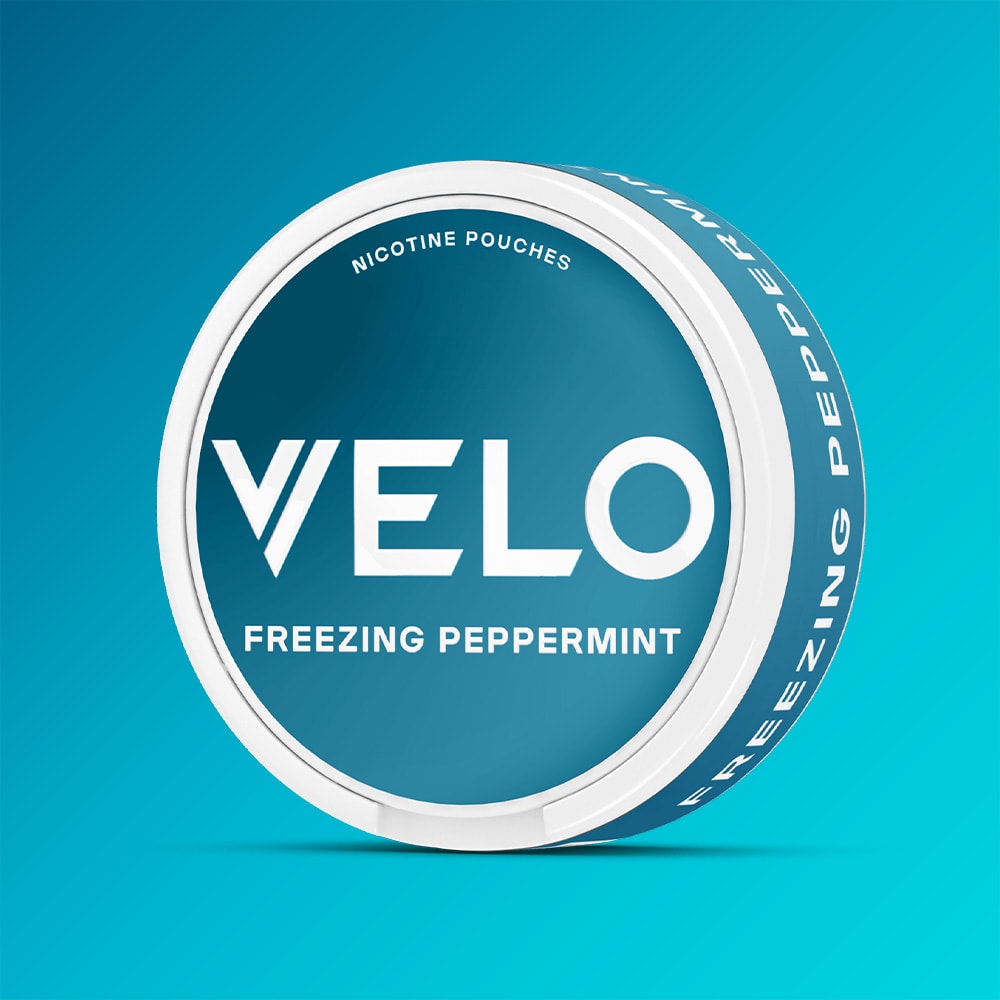 Circular container of VELO Freezing Peppermint nicotine pouches with a teal label featuring white text.