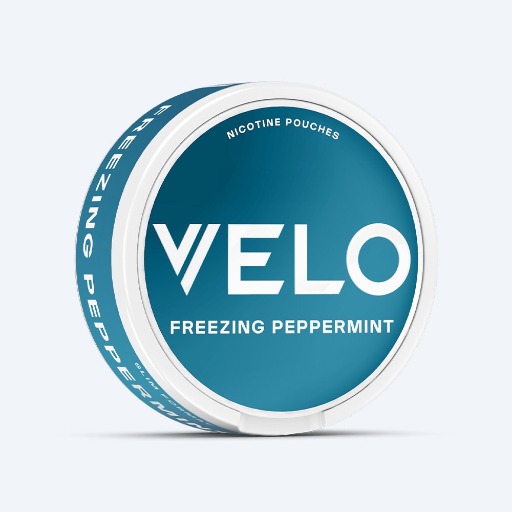 A round container of Freezing Peppermint VELO nicotine pouches in a teal and white color scheme.